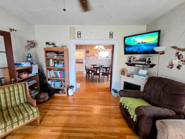 living room with light hardwood / wood-style floors and a chandelier