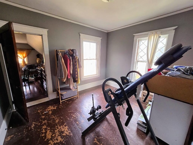 exercise area with dark hardwood / wood-style flooring, a wealth of natural light, vaulted ceiling, and ornamental molding