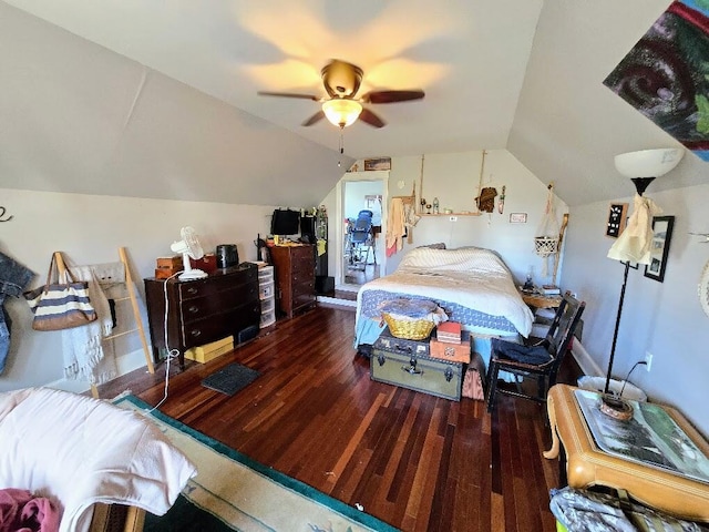 bedroom featuring dark hardwood / wood-style flooring, ceiling fan, and vaulted ceiling