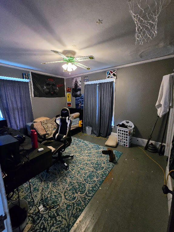 bedroom with a textured ceiling and ceiling fan