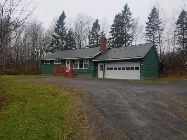 ranch-style home with a garage and a front lawn