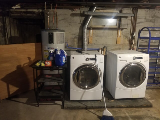 laundry area with independent washer and dryer and water heater