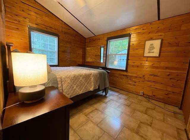 bedroom featuring wooden walls and vaulted ceiling