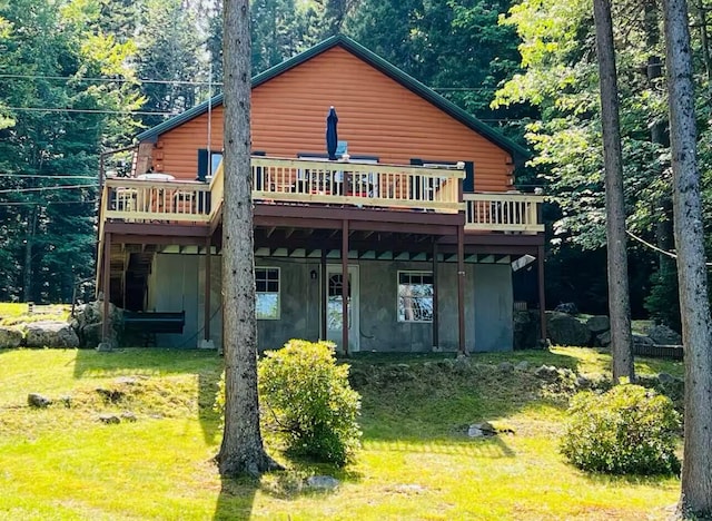 back of house with a lawn and a deck