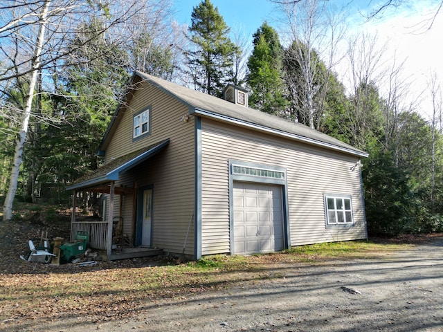 view of property exterior with a garage and a porch