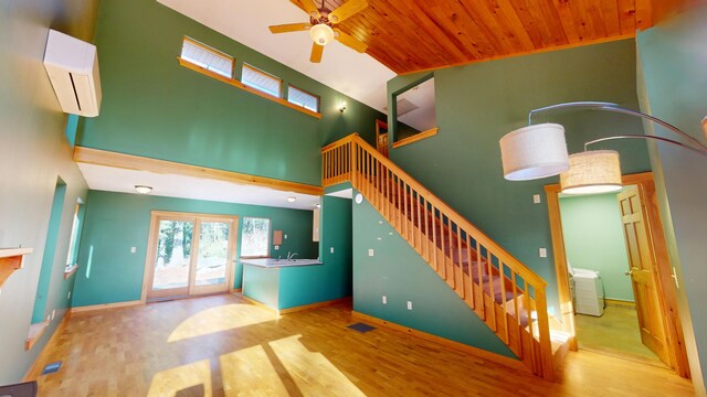 stairway with wood-type flooring, wood ceiling, sink, ceiling fan, and an AC wall unit