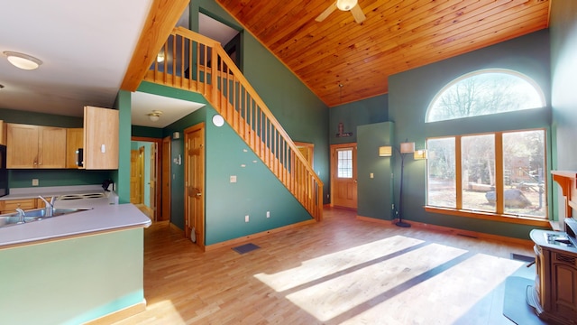 kitchen with sink, light brown cabinets, high vaulted ceiling, wood ceiling, and light wood-type flooring