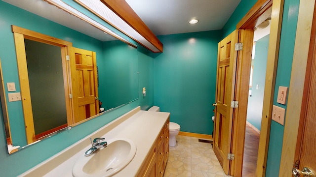 bathroom with toilet and vanity