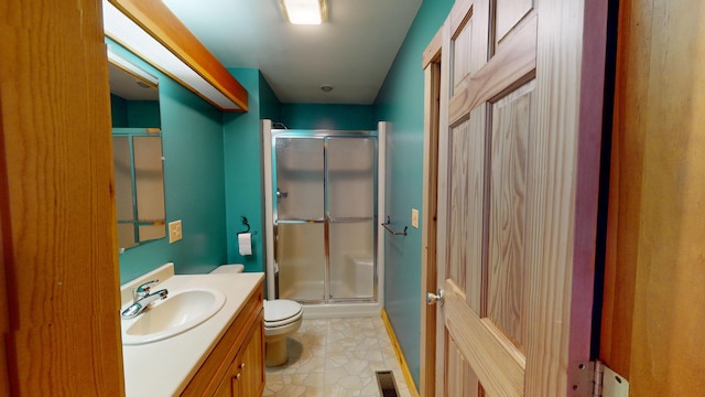 bathroom with walk in shower, tile patterned flooring, vanity, and toilet