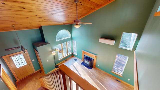 stairway featuring a wall unit AC, wood ceiling, hardwood / wood-style flooring, high vaulted ceiling, and ceiling fan