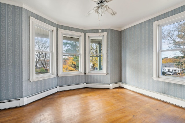 unfurnished room featuring hardwood / wood-style flooring, crown molding, and ceiling fan