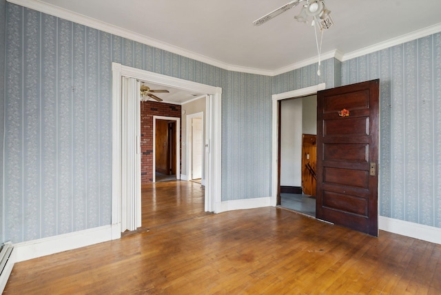 empty room featuring hardwood / wood-style flooring, ceiling fan, and crown molding