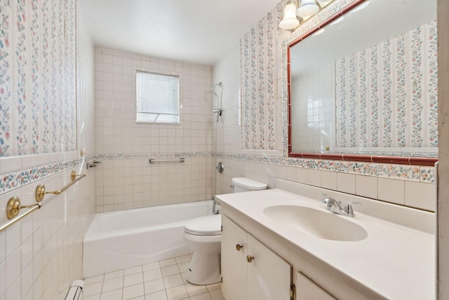 full bathroom featuring tile walls, tile patterned floors, vanity, toilet, and tiled shower / bath