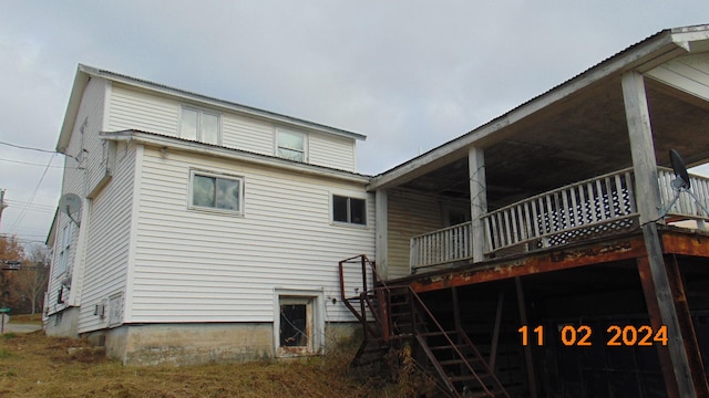 back of property featuring a wooden deck