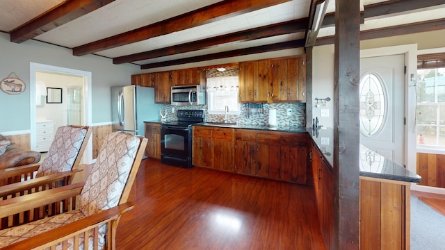 kitchen with a wealth of natural light, appliances with stainless steel finishes, dark wood-type flooring, and sink