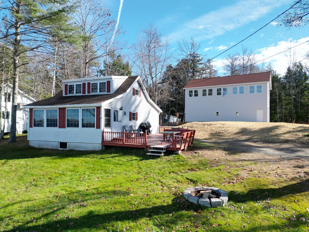 125 Perk Orock Landing Rd, Orono, ME 04473 - view of front facade featuring a front lawn, an outdoor fire pit, and a deck