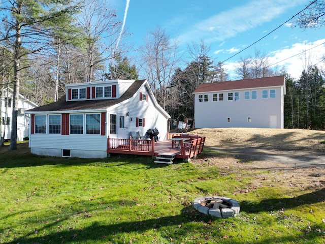 view of front facade featuring a front lawn, an outdoor fire pit, and a deck