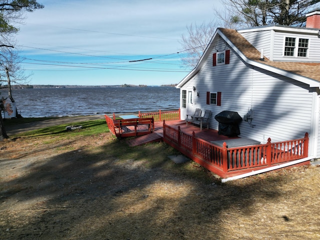 exterior space with a deck with water view