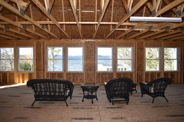 sunroom / solarium featuring a water view