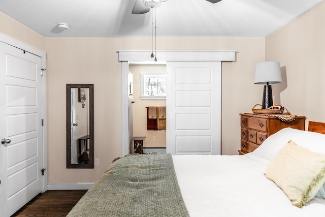 bedroom featuring dark hardwood / wood-style flooring and ceiling fan