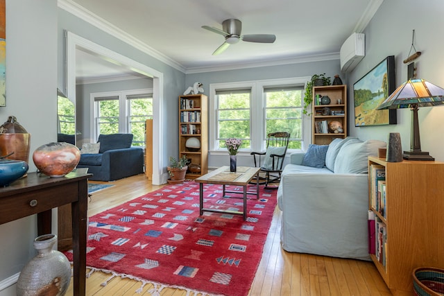 living room featuring an AC wall unit, ornamental molding, ceiling fan, and light hardwood / wood-style floors