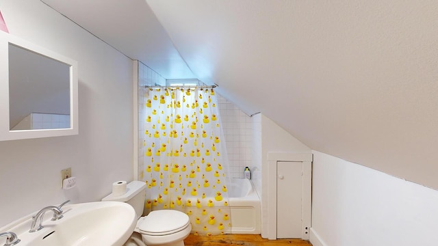 full bathroom with sink, vaulted ceiling, hardwood / wood-style flooring, toilet, and shower / bath combo with shower curtain