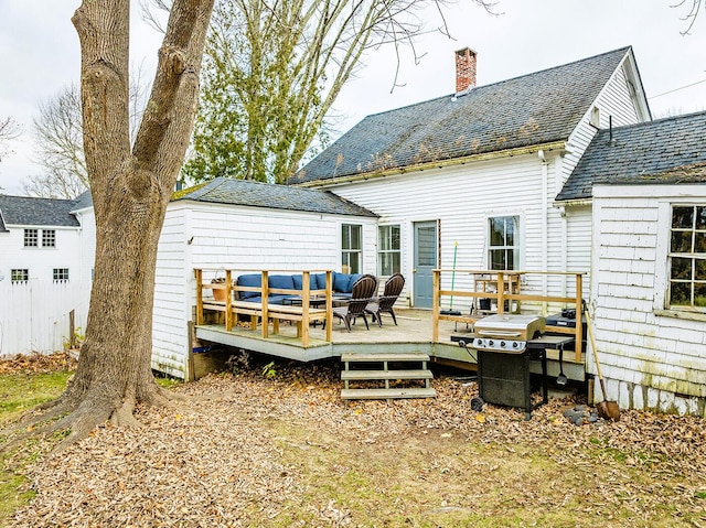 back of property with an outdoor hangout area and a wooden deck