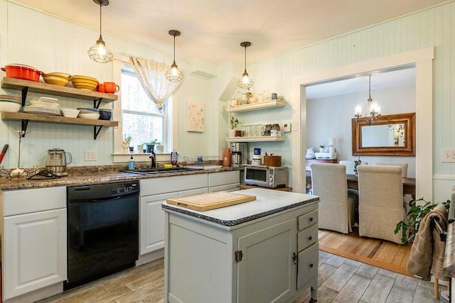 kitchen featuring white cabinets, pendant lighting, black dishwasher, and light hardwood / wood-style flooring