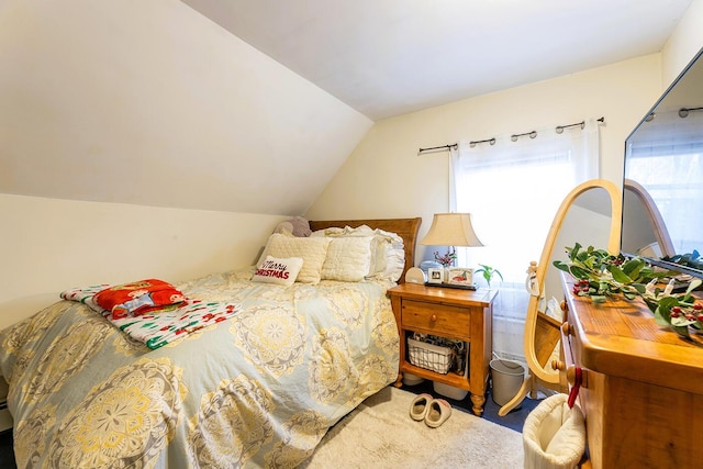 carpeted bedroom with vaulted ceiling