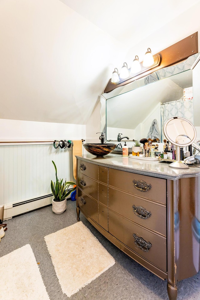 bathroom featuring vanity, lofted ceiling, and a baseboard heating unit