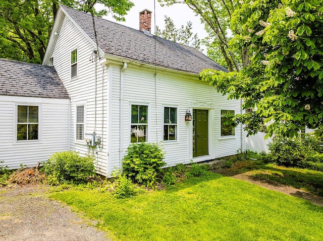 97 Chestnut St, Camden, ME 04843 - view of front facade with a chimney and a front lawn