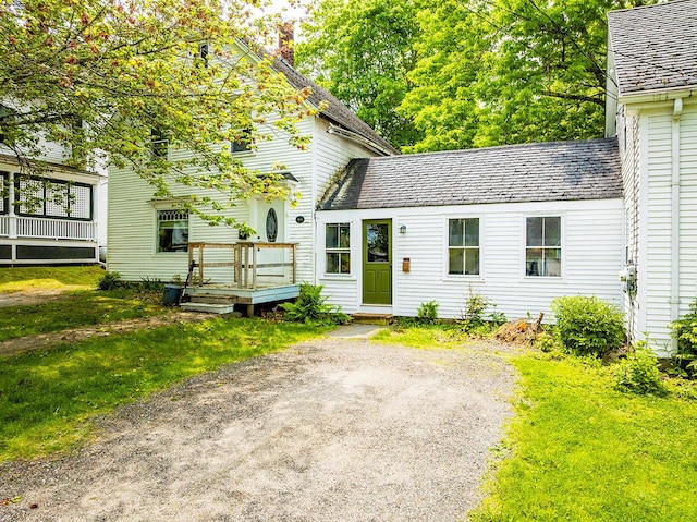 97 Chestnut St, Camden, ME 04843 - view of front of property with a deck, a chimney, and a front yard