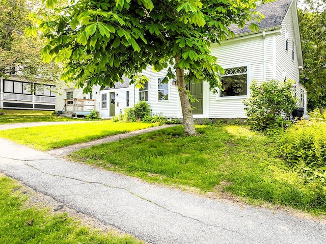97 Chestnut St, Camden, ME 04843 - view of front of home featuring roof with shingles, a wooden deck, and a front lawn