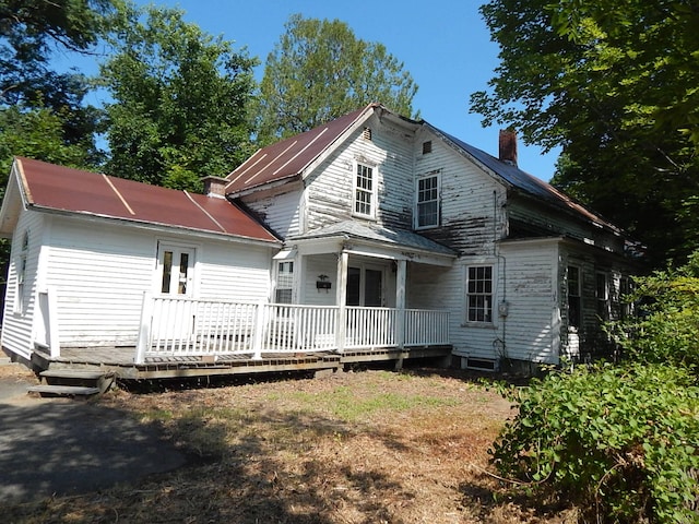 back of house featuring a deck