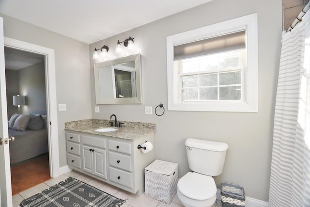 bathroom featuring tile patterned floors, vanity, and toilet