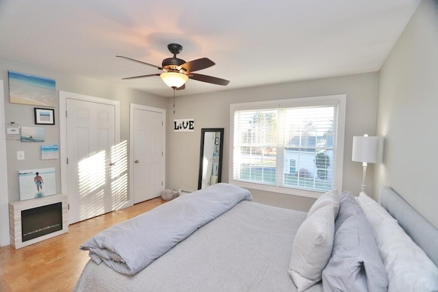 bedroom with light hardwood / wood-style flooring and ceiling fan