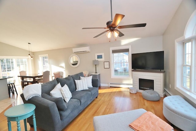 living room featuring a healthy amount of sunlight, an AC wall unit, and baseboard heating