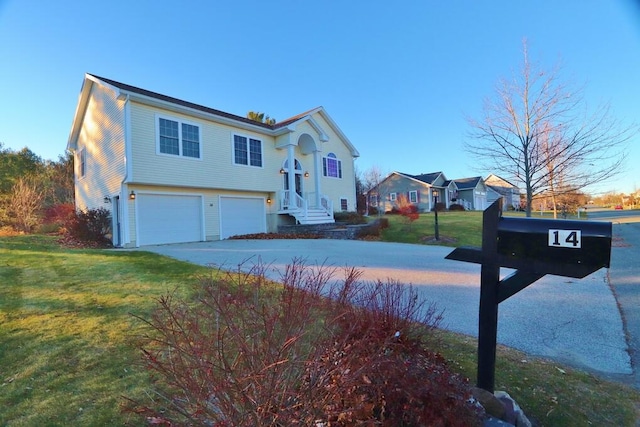 view of front facade featuring a garage and a front lawn