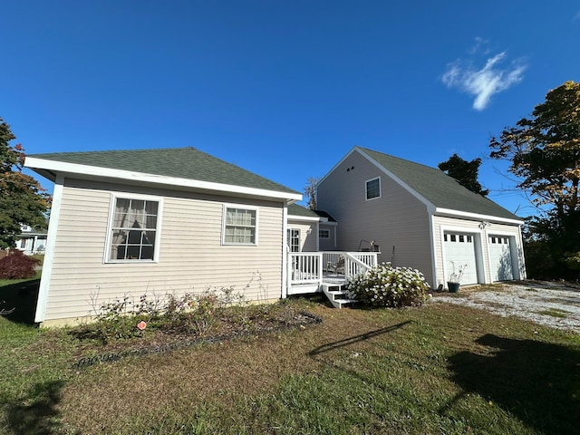 view of side of property featuring a garage and a yard