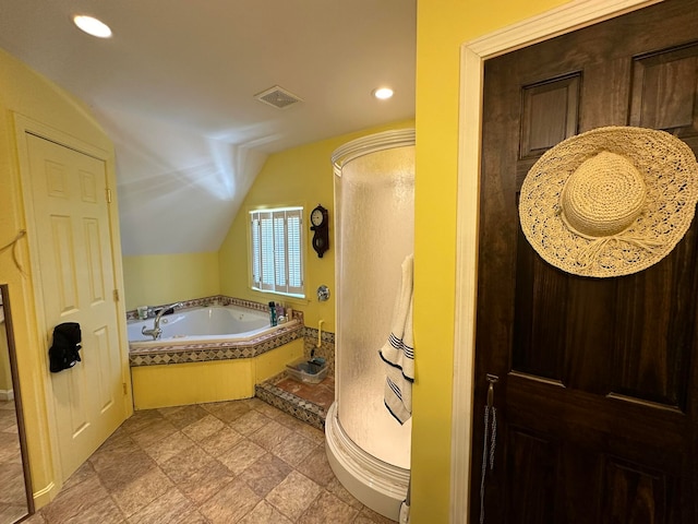 bathroom featuring lofted ceiling and plus walk in shower
