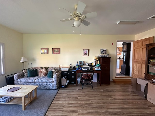 living room featuring hardwood / wood-style flooring and ceiling fan