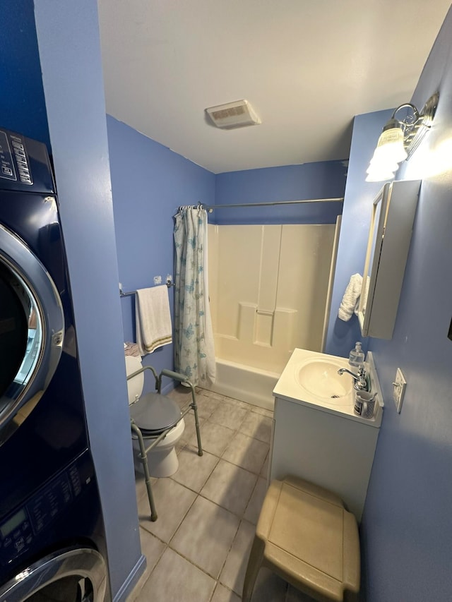 full bathroom featuring stacked washer / dryer, vanity, tile patterned flooring, toilet, and shower / bathtub combination with curtain