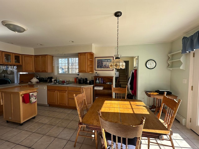 kitchen with ornamental molding, light tile patterned flooring, white dishwasher, hanging light fixtures, and sink