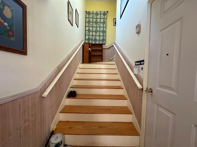 stairs with wood walls
