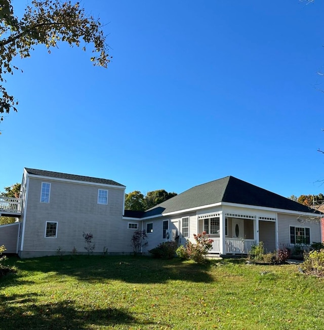 back of property featuring a lawn