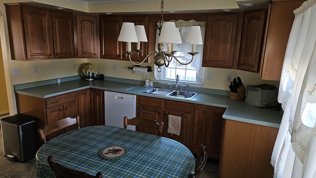 kitchen featuring hanging light fixtures, sink, and white dishwasher