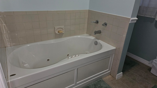 bathroom with a washtub and tile patterned floors