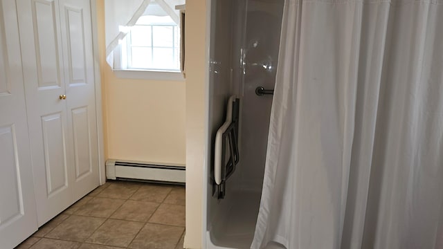 bathroom with tile patterned flooring and baseboard heating