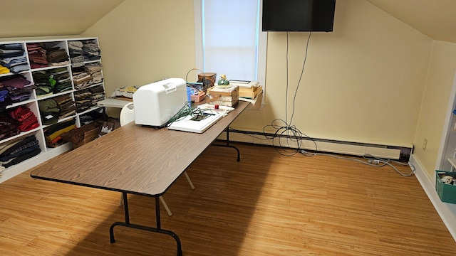 office space with baseboard heating, lofted ceiling, and hardwood / wood-style flooring