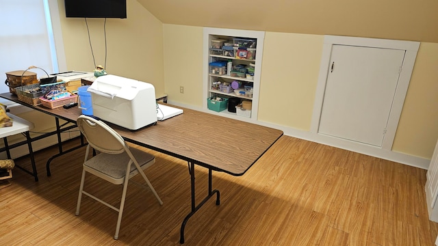 office area featuring wood-type flooring and a baseboard heating unit